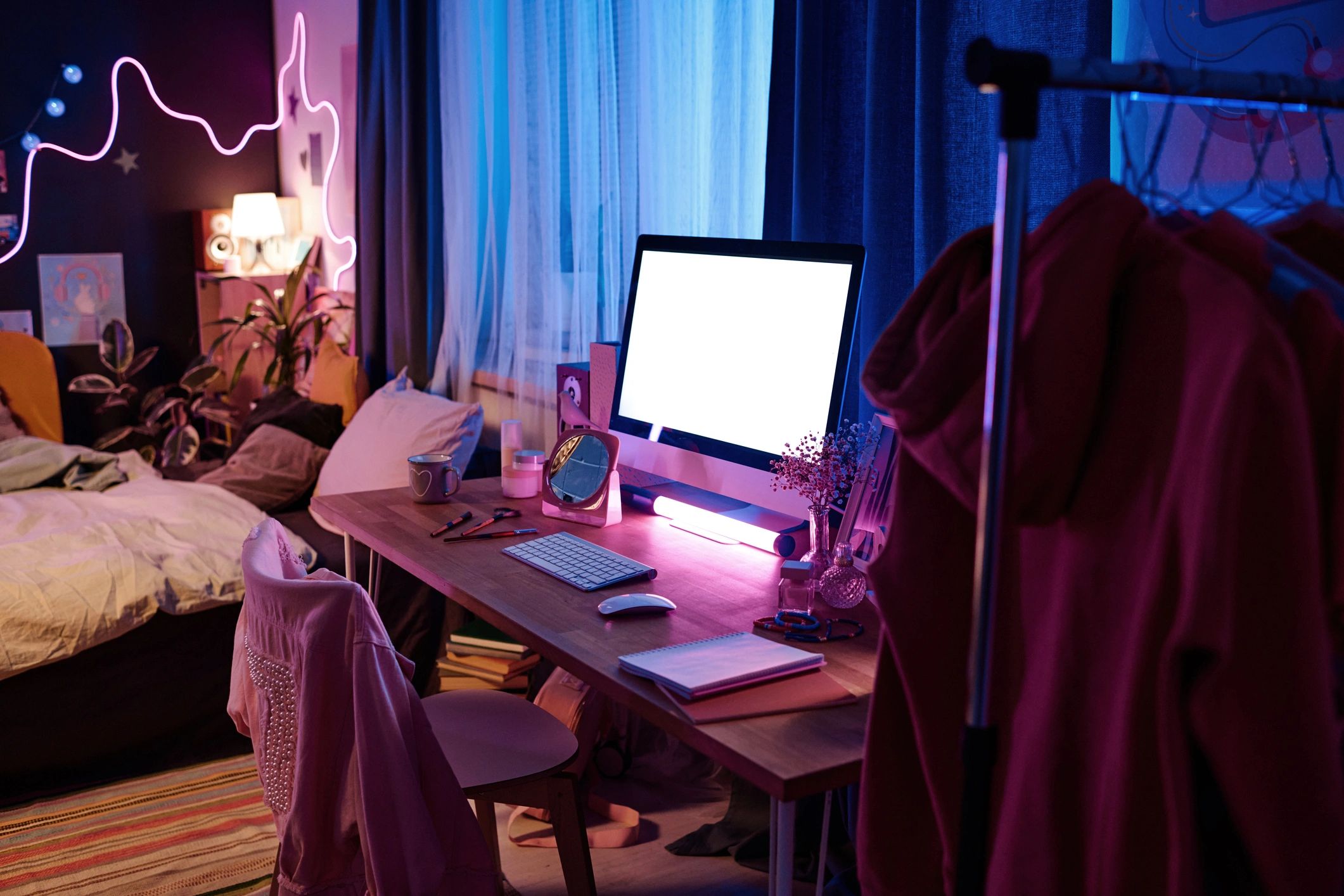 Gaming bedroom setup with neon lighting
